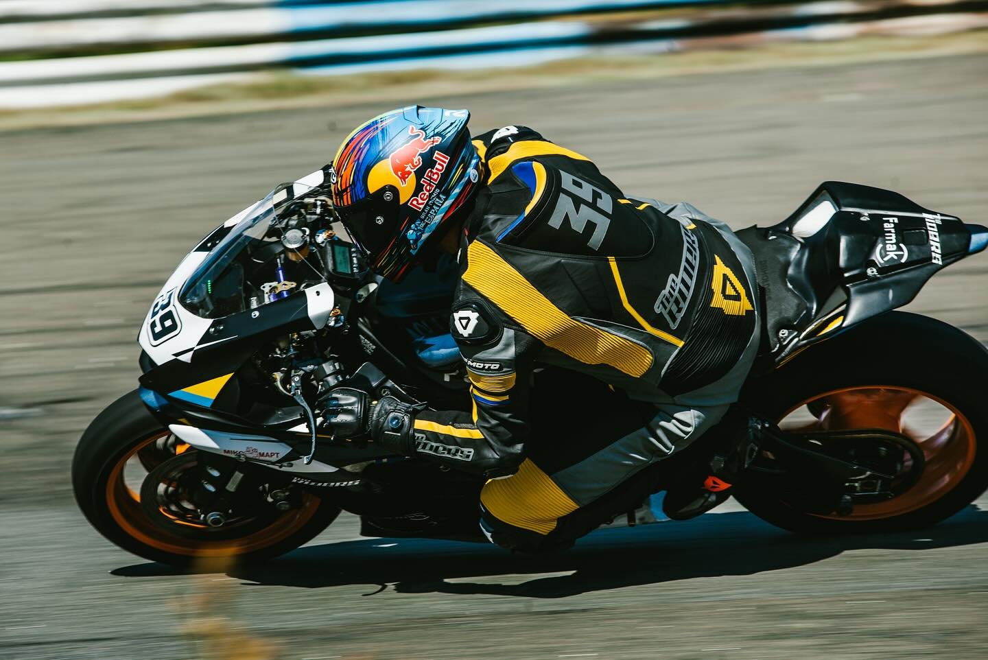 NFmoto rider on track in a custom leather race suit