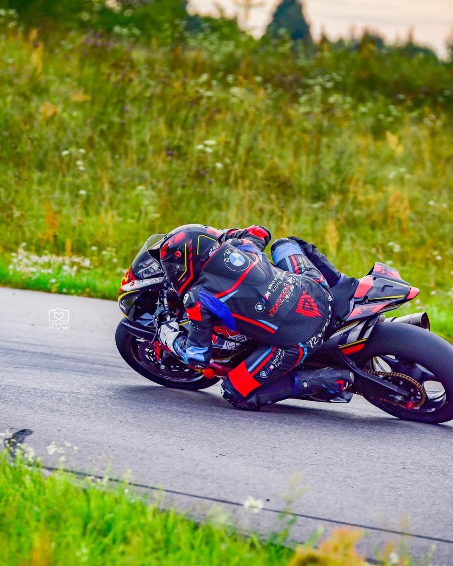 NFmoto rider on track in a custom leather race suit