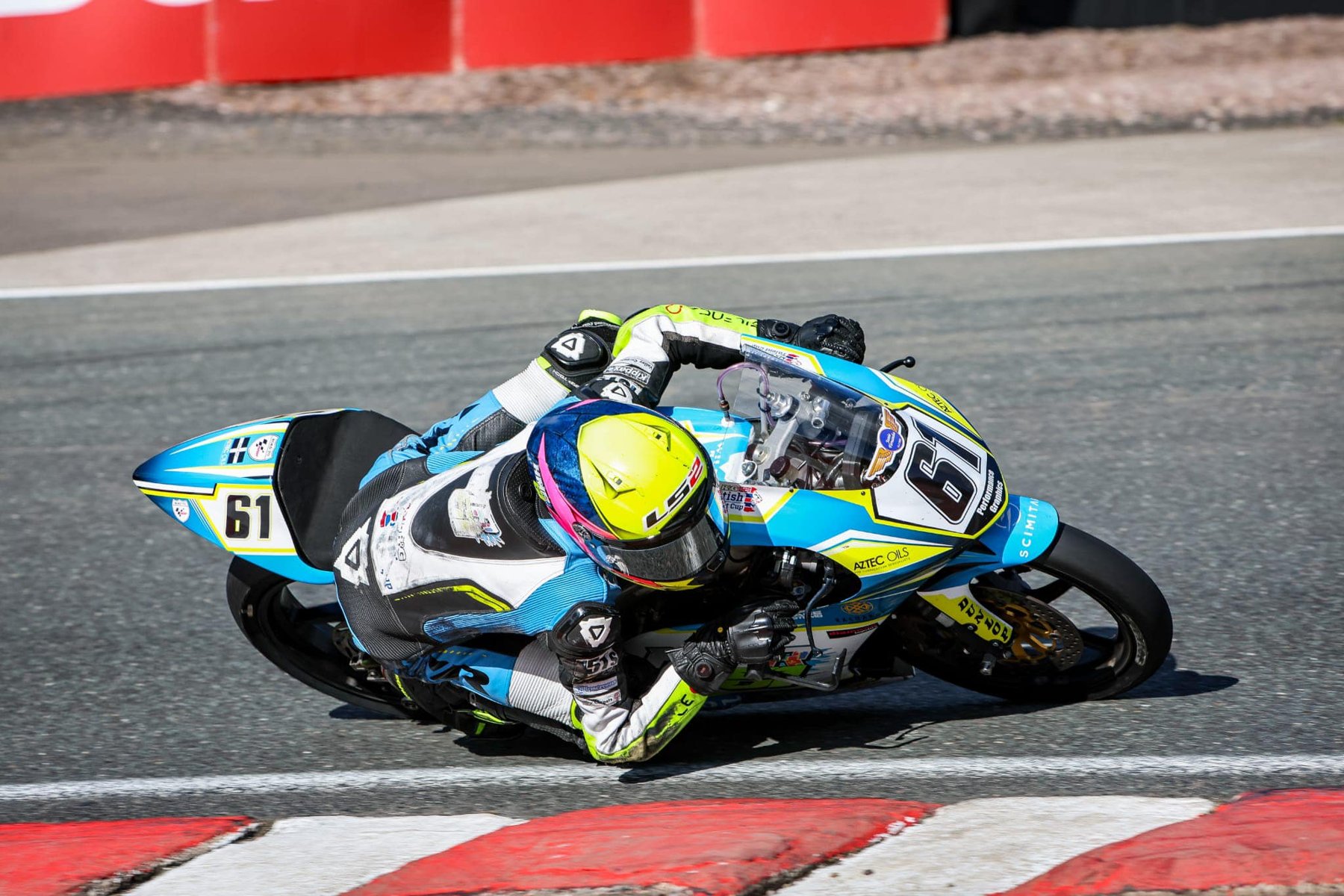 NFmoto rider on track in a custom leather race suit