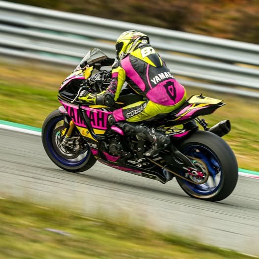 NFmoto rider on track in a custom leather race suit