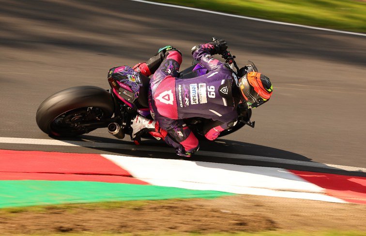 NFmoto rider on track in a custom leather race suit