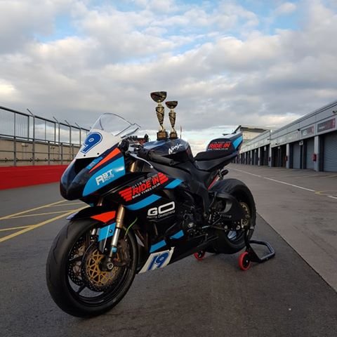 NFmoto rider on track in a custom leather race suit