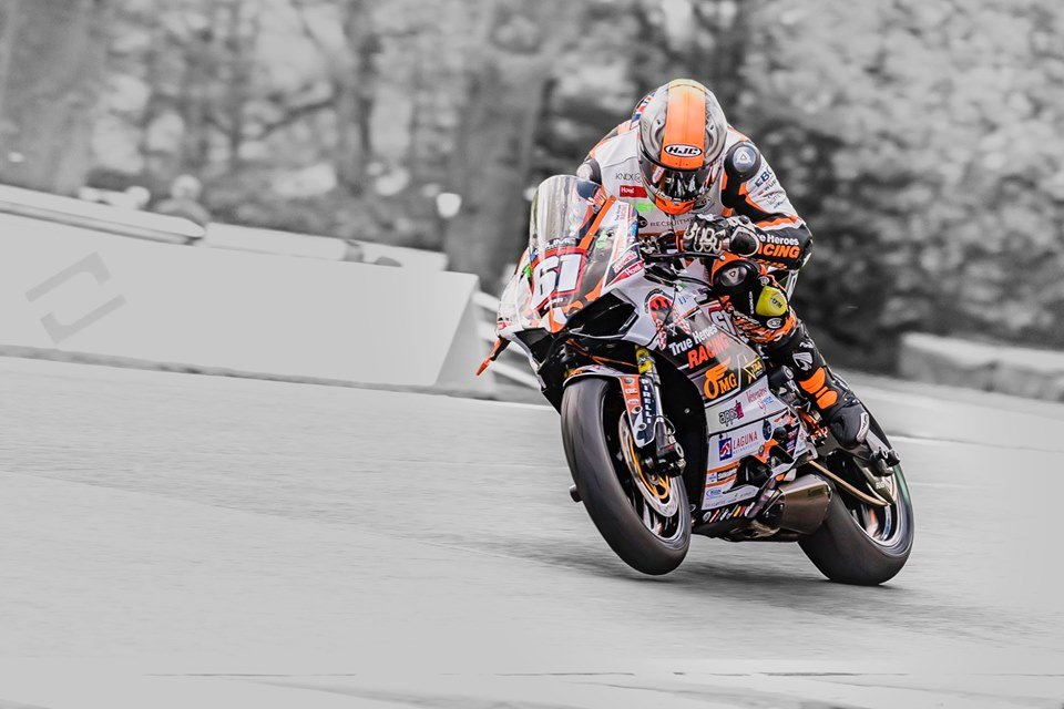 NFmoto rider on track in a custom leather race suit