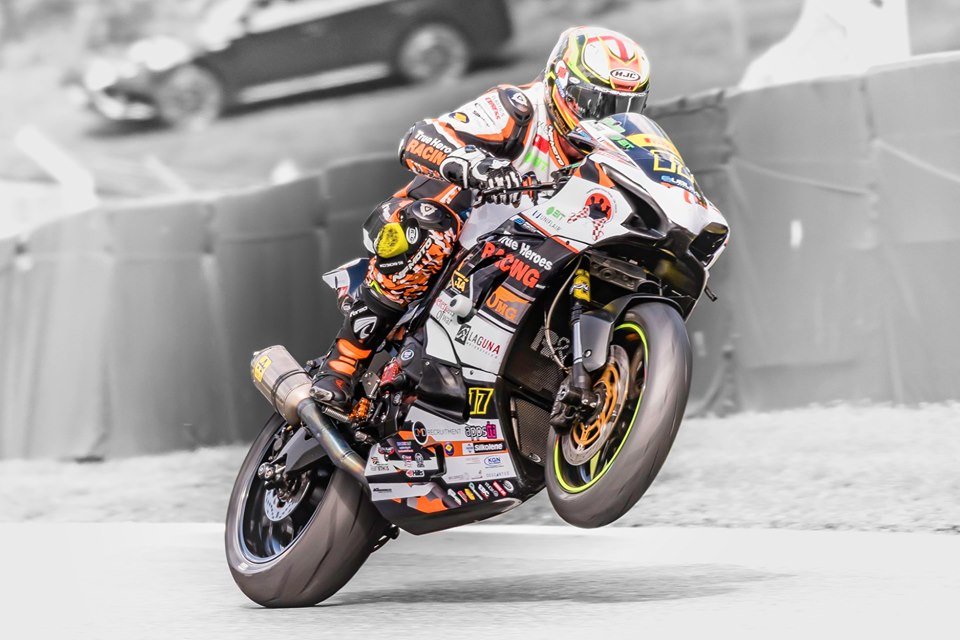 NFmoto rider on track in a custom leather race suit