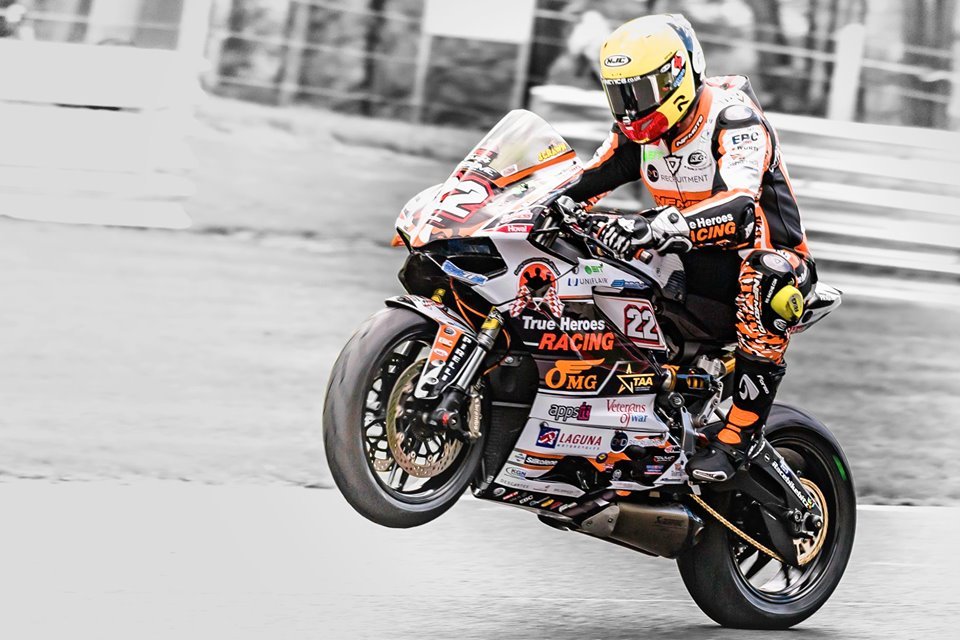 NFmoto rider on track in a custom leather race suit